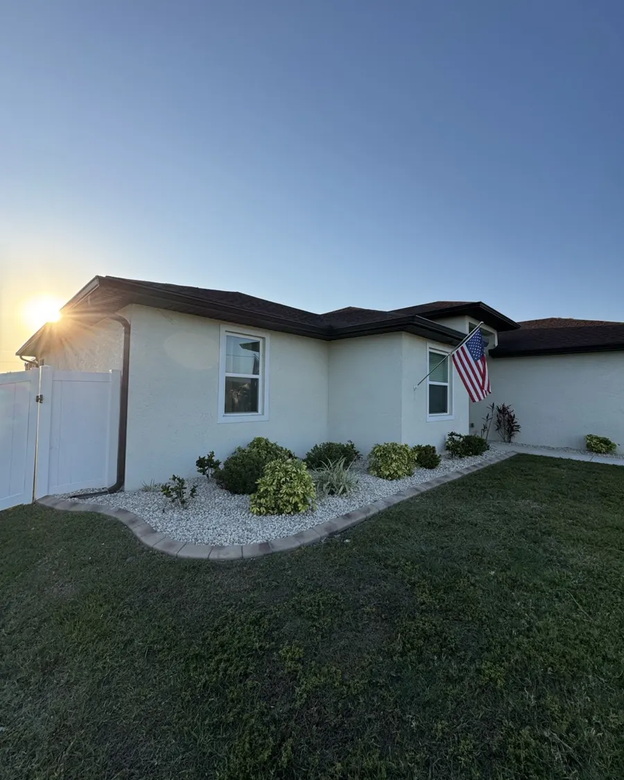 Home with American flag and a freshly mowed lawn